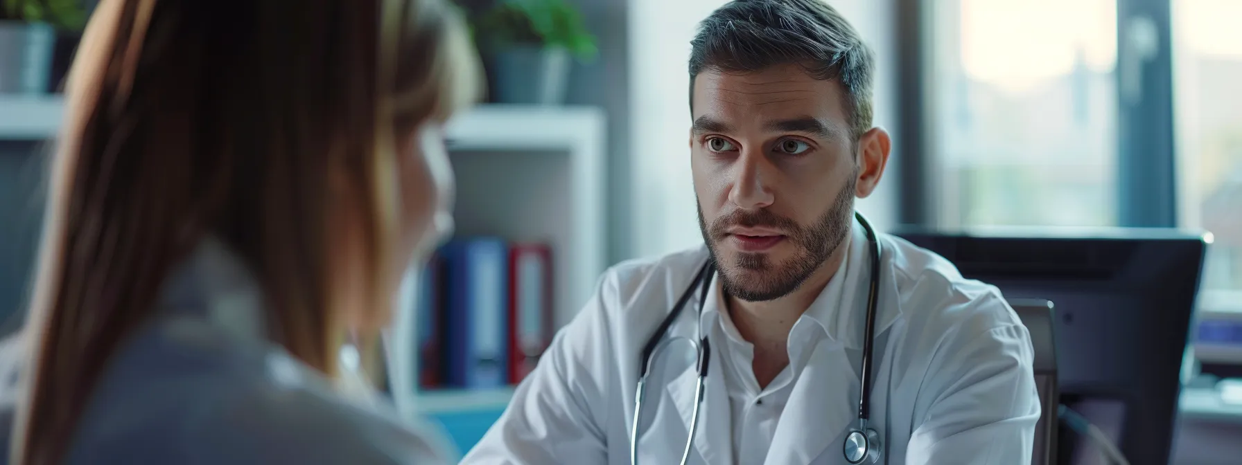 a doctor making eye contact and fully focused on a patient during a consultation, with an ai medical scribe handling the documentation in the background.